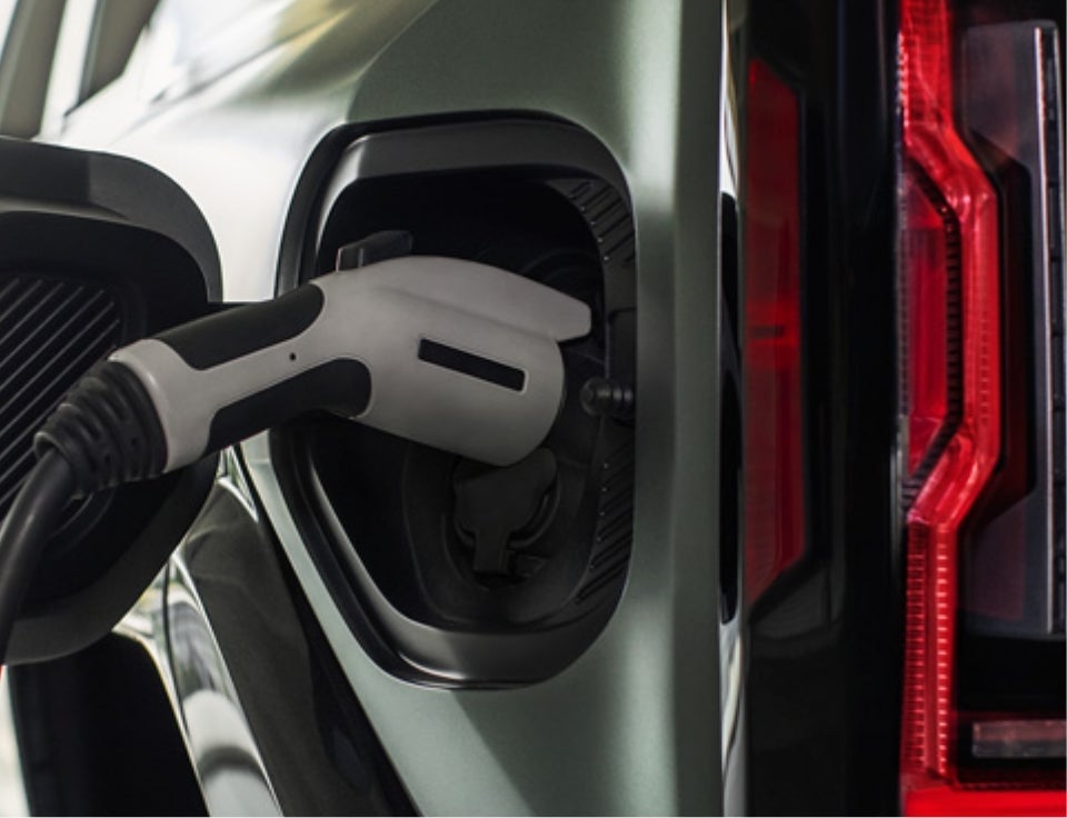 Close up of charging port with charger plugged in on a GMC Hummer EV SUV - Davidson Buick GMC of Rome in Rome NY
